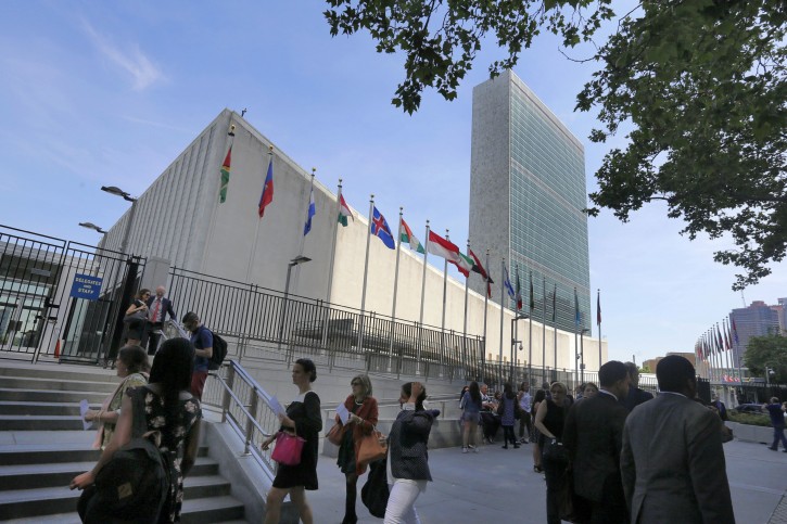 In this June 2, 2016 photo, people gather outside the United Nations visitors entrance. The number of people who take the U.N. tour has averaged around 200,000 a year for the past five years, and the U.N. is on track to host about 200,000 people on the tour this year as well.  (AP Photo/Richard Drew)