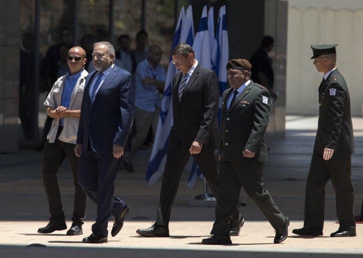 File: Avigdor Lieberman (2-L) is accompanied by his Chief of Staff Gadi Eisencott (2-R) as they walk to a line of officers during Lieberman's welcoming ceremony in the Defense Ministry in Tel Aviv, Israel, 31 May 2016. EPA/JIM HOLLANDER