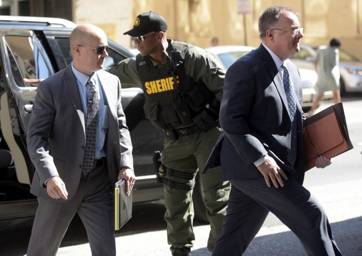 Lt. Brian Rice, left, one of the six members of the Baltimore Police Department charged in connection to the death of Freddie Gray, arrives with attorney Mike Davey, right, at a courthouse to hear a judge's ruling in his trial in Baltimore, Monday, July 18, 2016. Rice is the fourth of the six officers charged to go on trial in the 2015 death of Freddie Gray. (AP Photo/Steve Ruark)
