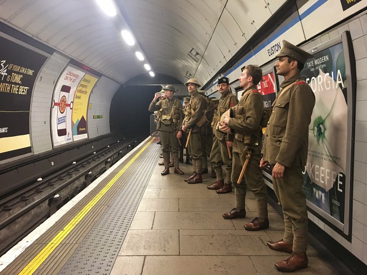 Men dressed as First World War soldiers stand on the platform in Euston underground station in London, to mark 100-years since the start of the Battle of the Somme, early Friday July 1, 2016. London commuters were met by the eerie sight of people dressed as World War I soldiers as they made their way to work Friday, with the soldiers singing wartime songs or remaining silent, revealed later Friday as a tribute, the work of Turner Prize-winning artist Jeremy Deller, National Theatre Director Rufus Norris and thousands of volunteers. (Sarah Perry / PA via AP)