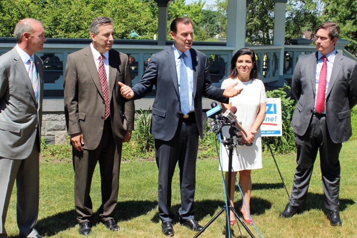 Thomas Suozzi, center, Democratic candidate for a seat in the U.S. House of Representatives from the 3rd Congressional District in New York, speaks at a news conference, in Manhasset, NY, Thursday, June 30, 2016. Suozzi, who lost a primary race for governor in 2006, and then was ousted as Nassau County executive in 2009, is seeking a political comeback (AP Photo/Frank Eltman)