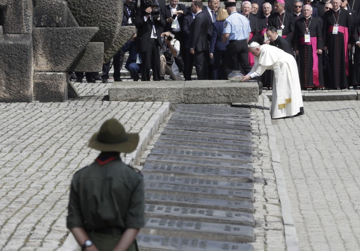 Pope Francis prays in front of the Memorial at the former Nazi Death Camp Auschwitz-Birkenau, in Oswiecim, Poland, Friday, July 29, 2016.  AP