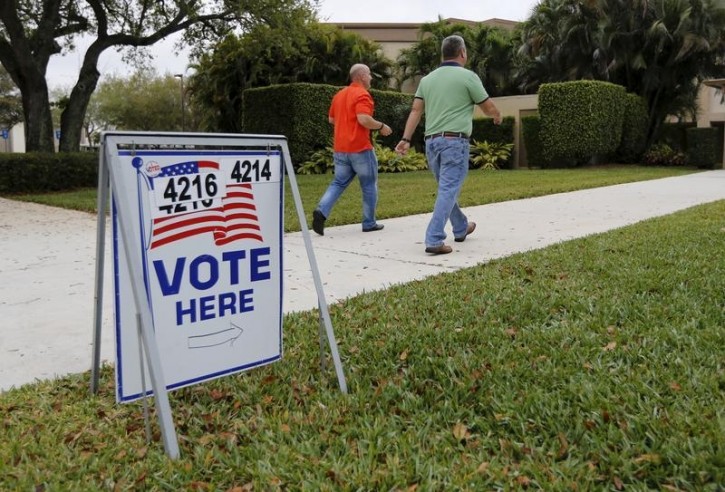 FILE - Voters walk to a polling precinct on primary day in Florida for the U.S. presidential election in Boca Raton, Florida March 15, 2016. REUTERS/Joe Skipper