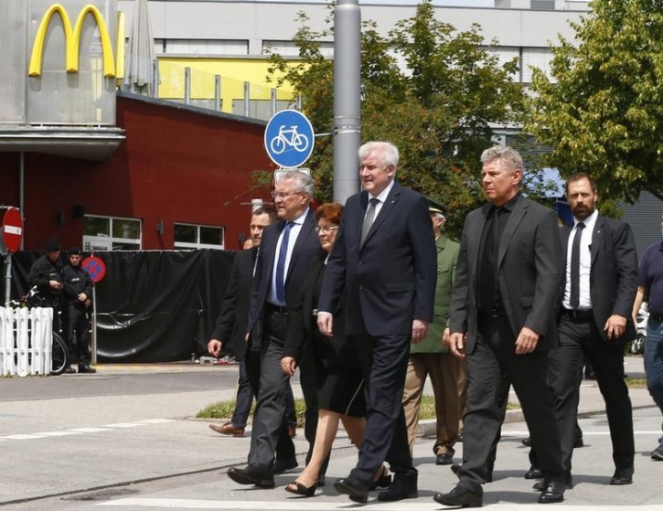 Bavarian Interior Minister Joachim Herrmann, Bavarian Prime Minister Horst Seehoffer and Munich Mayor Dieter Reiter (L-R) visit a scene near the Olympia shopping mall, where yesterday's shooting rampage started, in Munich, Germany July 23, 2016.  REUTERS/Arnd Wiegmann