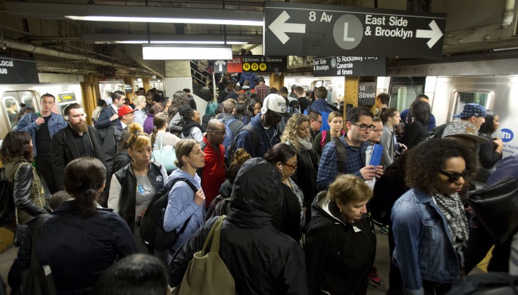 In this May 24, 2016, photo, L train commuters work their way across a crowded subway platform in New York. The L train's tunnel between Manhattan and Brooklyn will close for 18 months, starting in 2019 to repair damage caused by Superstorm Sandy. (AP Photo/Mark Lennihan)