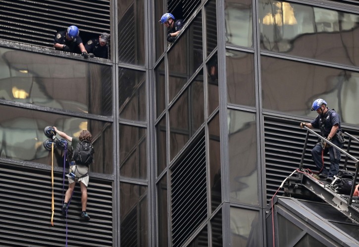A man scales the east side of Trump Tower using suction cups, Wednesday, Aug. 10, 2016, in New York. A police spokeswoman says officers responded to Donald Trump's namesake skyscraper on Fifth Avenue in Manhattan but had no further information. The 58-story building is headquarters to the Republican presidential nominee's campaign. He also lives there.(AP Photo/Julie Jacobson)