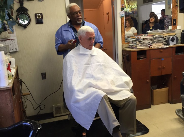In this photo provided by KYW Newsradio reporter Jim Melwert, Republican Vice Presidential nominee Mike Pence gets his hair trimmed by barber Henry Jones in Norristown, Pennsylvania on Tuesday, August 23, 2016. (Jim Melwert/KYW Newsradio)