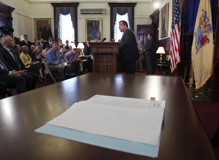 New Jersey Gov. Chris Christie addresses a gathering after signing legislation at the Statehouse that would bar the state's public pension fund from investing with companies that boycott Israel or Israeli businesses, Tuesday, Aug. 16, 2016, in Trenton, N.J. The legislation requires the State Investment Council, which manages more than $80 billion in pension assets, to identify any potential investments in companies with Israeli boycotts and to divest from them. (AP Photo/Mel Evans)