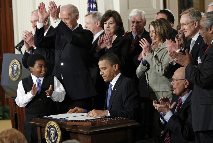 FILE -In this March 23, 2010, file photo President Barack Obama is applauded after signing the Affordable Care Act into law in the East Room of the White House in Washington.  If the law survives Supreme Court scrutiny, it will be nearly a decade before all its major pieces are in place, and even if he is re-elected, Obama won't be in office to oversee completion of his biggest domestic policy accomplishment, assuming Republicans don't succeed in repealing it.  (AP Photo/Charles Dharapak, File)