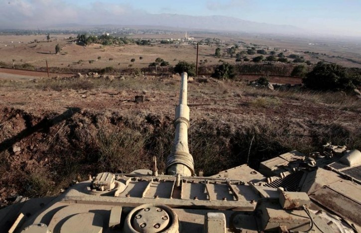 FILE - An old Israeli tank is positioned near the Israeli-Syrian border September 7, 2007. Reuters