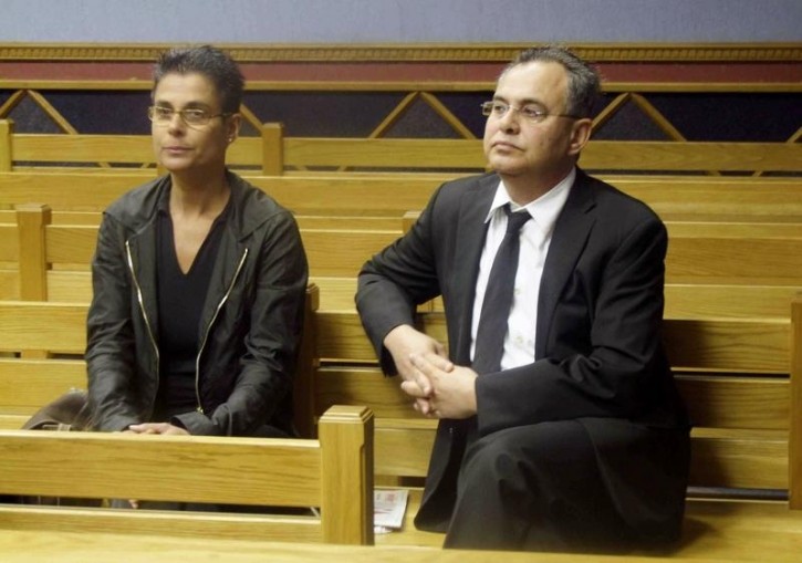 FILE - Fugitive U.S. millionaire Jacob "Kobi" Alexander sits with his wife Hanna, as he awaits the start of his extradition hearing in Windhoek, September 17, 2008. REUTERS
