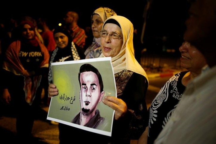The mother of the hunger-striking Palestinian prisoner Bilal Kayed holds his picture during a protest in favour of his release, at Barzilai Hospital in the southern Israeli city of Ashkelon August 9, 2016 REUTERS/Amir Cohen 