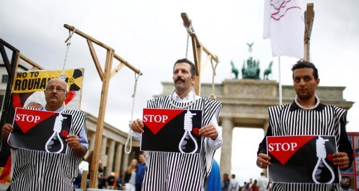 FILE - People stage a protest against executions by Iran, in front of the Brandenburg gate in Berlin, Germany, August 12, 2016. REUTERS/Hannibal Hanschke 