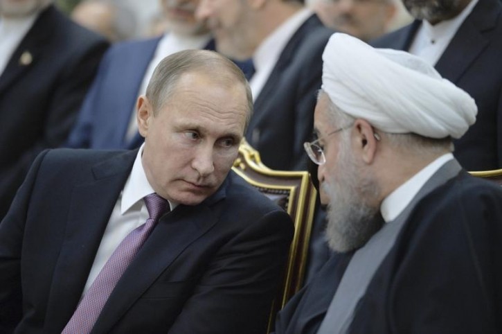 FILE - Russian President Vladimir Putin (L) speaks with his Iranian counterpart Hassan Rouhani during a signing ceremony after the talks in Tehran, Iran, November 23, 2015. Picture taken November 23, 2015. REUTERS/Alexei 
