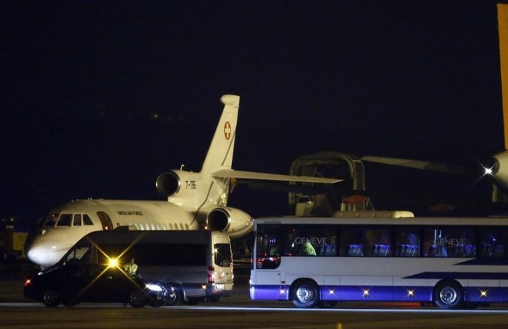 FILE - A bus and a van are parcked in front of a plane carrying three Iranian-Americans, who left Tehran under a prisoner swap, after it landed at Cointrin airport in Geneva, Switzerland January 17, 2016.  REUTERS/Denis Balibouse 