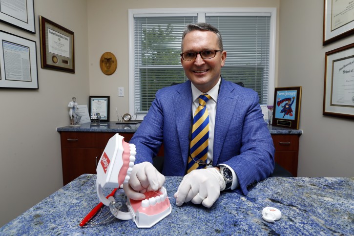 Dr. Wayne Aldredge, president of the American Academy of Periodontology, sits for a photo at his office in Holmdel, N.J. Aldredge acknowledges the weak scientific evidence and the brief duration of many studies on flossing, but says that the impact of floss might be clearer if researchers focused on patients at the highest risk of gum disease, such as diabetics and smokers. (AP Photo/Julio Cortez)
