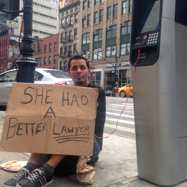  In this Aug. 16, 2016 photo, Matthew Kane charges his phone while panhandling at a wi-fi kiosk at 39th Street and 8th Avenue in New York. Kane, who  said he's couch surfing in New York after moving here recently from Pittsburg, was taking advantage of an ambitious public-private partnership that has converted hundreds of obsolete New York City phone booths into wi-fi kiosks offering free internet access, phone charging and domestic calls.. (AP Photo/Karen Matthews)
