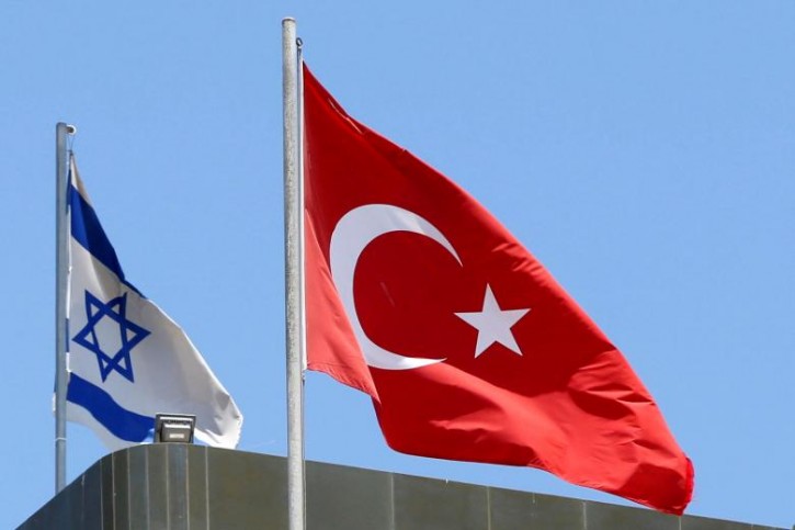 A Turkish flag flutters atop the Turkish embassy as an Israeli flag is seen nearby, in Tel Aviv, Israel June 26, 2016.  REUTERS/Baz Ratner/File Photo