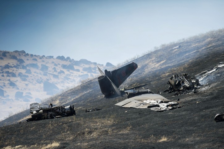 An aircraft assigned to the 1st Reconnaissance squadron at Beale Air Force Base and on a training mission went down on the lower slopes of the Sutter Buttes on Tuesday, Sept. 20, 2016 in Sutter County, Calif. The U.S. Air Force says one pilot was killed, and one was injured after they ejected from the plane. (Hector Amezcua/The Sacramento Bee via AP)
