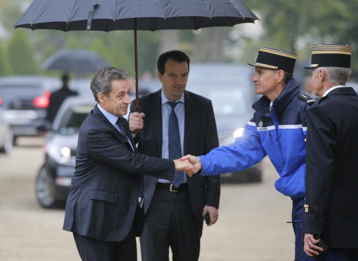 Former French President Nicolas Sarkozy, left, shakes hands with a Gendarme as he arrives to a ceremony for victims of terrorism in Paris, Monday Sept.19, 2016. French President Francois Hollande presides over a national ceremony to pay tribute to victims of terrorist attacks including that targeting Nice on Bastille Day. (AP Photo/Michel Euler, Pool)