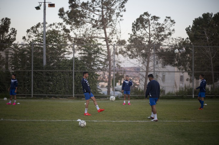 In this Thursday, Sept. 22, 2016 photo, Beitar Shabi Givat Zeev soccer club players train, in the West Bank Jewish settlement of Givat Zeev, near Jerusalem. Soccer clubs based in Israeli West Bank settlements are at the center of a showdown between Israelis and Palestinians that is set to draw soccer's global governing body FIFA into a tense dispute over Mideast politics. The Palestinians are pushing FIFA to declare the teams illegal at a meeting in Switzerland next month. (AP Photo/Ariel Schalit)