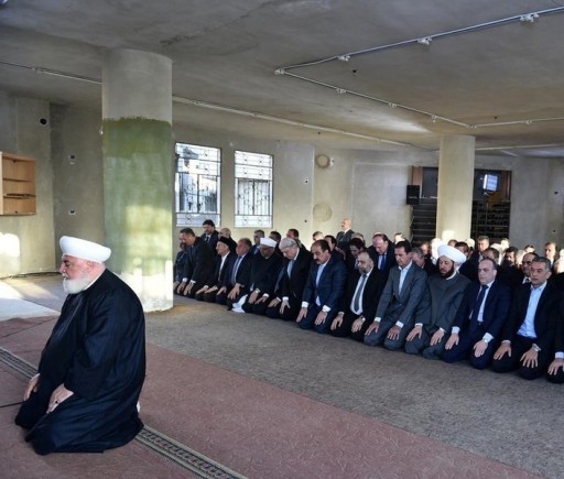 Syria's president Bashar al-Assad(4th R), prays at a mosque in a Damascus suburb of Daraya, Syria in this handout picture provided by SANA on September 12, 2016. SANA/Handout via REUTERS 