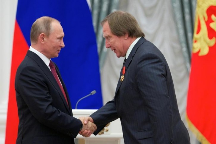 FILE - Russian President Vladimir Putin (L) shakes hands with artistic director of St. Petersburg House of Music Sergei Roldugin after awarding him during a ceremony at the Kremlin in Moscow, Russia, September 22, 2016. REUTERS/Ivan Sekretarev/Pool 