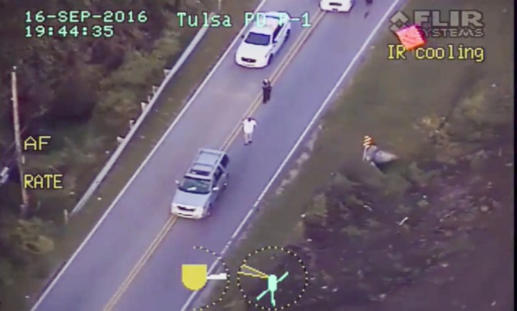  A frame grab from video released by the Tulsa, Oklahoma, USA, Police Department and acquired on 20 September 2016 reportedly shows Terence Crutcher (R) walking with his hands in the air as he is confronted by police after his automobile broke down in Tulsa, Oklahoma, USA, on 16 September 2016. EPA