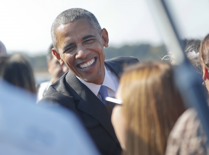 President Barack Obama smiles as he begins to greet guests on the tarmac upon his arrival on Air Force One at Raleigh-Durham International airport in Morrisville, NC., Wednesday, Nov. 2, 2016. Obama is in North Carolina to help turn out the vote for Democratic presidential candidate Hillary Clinton with a rally in Chapel Hill. It's the first of two visits Obama has planned this week to North Carolina. (AP Photo/Pablo Martinez Monsivais)