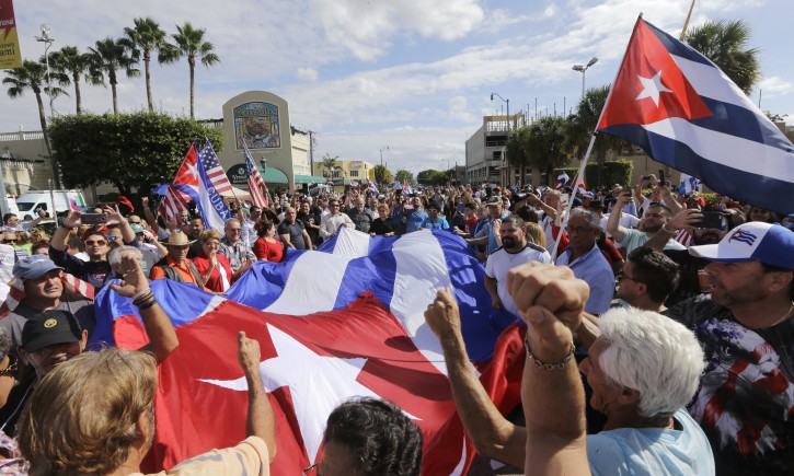 Cuban-Americans react to the death of Fidel Castro, Saturday, Nov. 26, 2016, in the Little Havana area in Miami. Castro, who led a rebel army to improbable victory in Cuba, embraced Soviet-style communism and defied the power of 10 U.S. presidents during his half century rule, died at age 90.  (AP Photo/Alan Diaz)