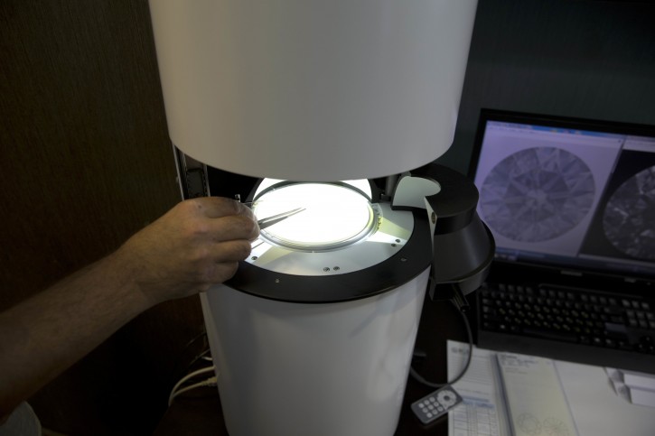 Sarine Technologies Ltd. employ puts a diamond in a machine that can instantly grade the clarity of polished diamonds in  Ramat Gan, Israel, Thursday, Nov. 10, 2016. An Israeli high-tech company has invented a machine that can instantly grade the clarity of polished diamonds _ a development the company said Thursday will bring new standards to a painstaking process that has long been subject to the whims of human subjectivity. (AP Photo/Ariel Schalit)