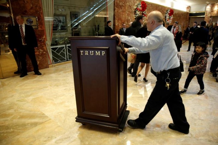 A worker pushes a podium through the lobby at Trump Tower where U.S. President-elect Donald Trump lives in New York, U.S., November 28, 2016. Reuters