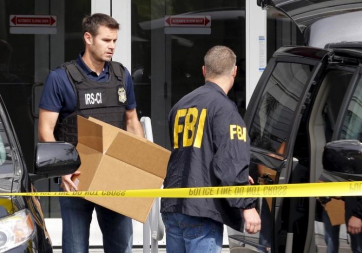 FILE - FBI agents remove boxes and other items from the offices of Imagina in Miami, Florida December 3, 2015.   REUTERS/Joe Skipper