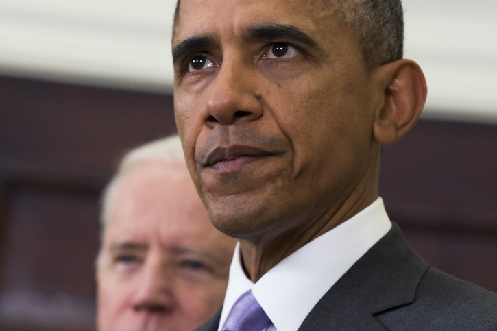 Vice President Joe Biden listens at left as President Barack Obama speaks about the Islamic State group, Wednesday, Feb. 11, 2015, in the Roosevelt Room of the White House in Washington. Obama asked the U.S. Congress on Wednesday to authorize military force to "degrade and defeat" Islamic State forces in the Middle East without sustained, large-scale U.S. ground combat operations, setting lawmakers on a path toward their first war powers vote in 13 years. (AP Photo/Evan Vucci)