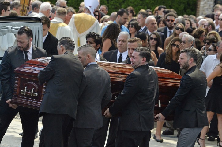 FILE - In this Aug. 6, 2016 file photo, mourners carry the casket of Karina Vetrano from St. Helen's Church following her funeral in the Howard Beach section of the Queens borough of New York. With a DNA profile, but no name to match it in the search for her killer, prosecutors are now seeking permission to try an emerging approach: using the DNA to search for the killer's relatives. (Steven Sunshine/Newsday via AP, File)