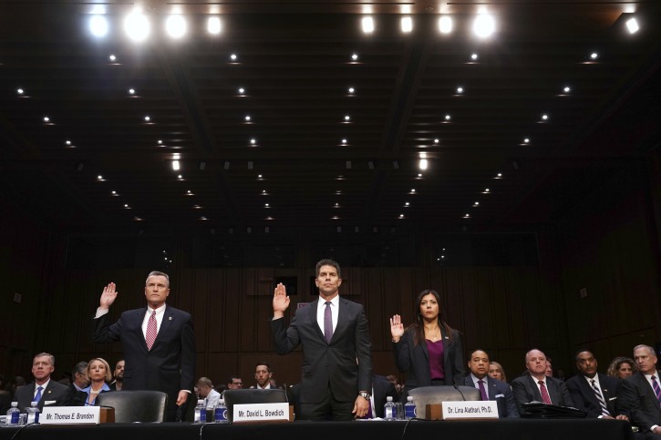 Thomas Brandon, deputy director of the Bureau of Alcohol, Tobacco, Firearms and Explosives, left, David Bowdich, associate deputy director of the Federal Bureau of Investigation, and Lina Alathari, a researcher with the U.S. Secret Service, are sworn in to testify at a Senate Judiciary Committee hearing on the Parkland, Fla., school shootings and school safety, Wednesday, March 14, 2018, on Capitol Hill in Washington. (AP Photo/Jacquelyn Martin)