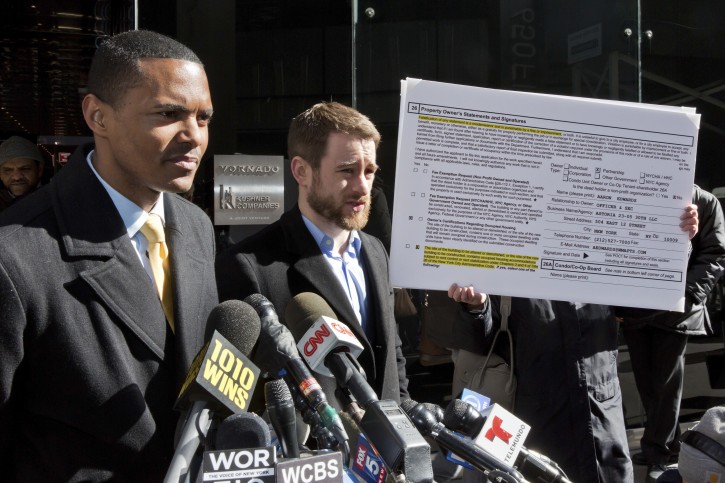 New York City Council Member Ritchie Torres, left, and Housing Rights Initiative Executive Director Aaron Carr address a news conference outside Kushner Companies headquarters, in New York,  Monday, March 19, 2018.(AP Photo/Richard Drew)
