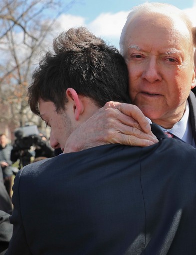 FILE - In this Tuesday, March 13, 2018. file photo, Sen. Orrin Hatch, R-Utah, center, hugs Kyle Kashuv, 16, and Patrick Petty, 17, both from Parkland, Fla., following a news conference on Capitol Hill in Washington. A Florida school district is looking into claims that a Marjory Stoneman Douglas teacher said Kashuv was acting like Adolf Hitler. The Sun Sentinel reports the controversy involves history teacher Greg Pittman, who supports gun control, and junior Kyle Kashuv, who has defended gun rights following the mass shooting at their school. (AP Photo/Pablo Martinez Monsivais, File)