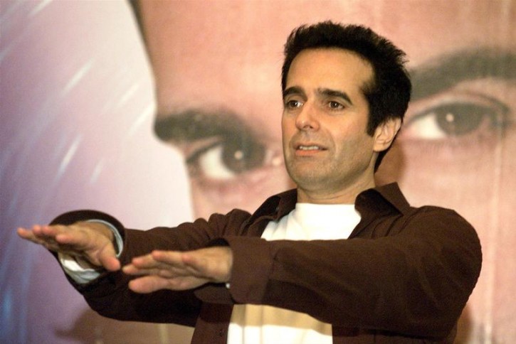 FILE - World-renowned U.S. magician David Copperfield shows some tricks during a news conference in Shanghai July 22, 2002. Reuters