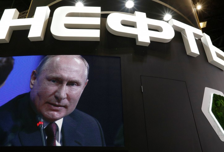Russian President Vladimir Putin is seen on a screen at the stand of Russian state oil major Rosneft during the St. Petersburg International Economic Forum (SPIEF), Russia May 25, 2018. REUTERS/Sergei Karpukhin