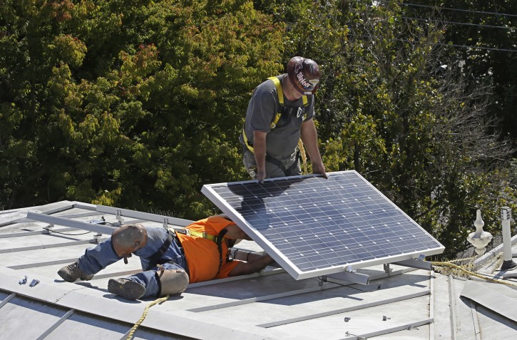 FILE - In this Oct. 16, 2015 file photo a solar panel is installed on the roof of the Old Governor's Mansion State Historic Park in Sacramento, Calif.  (AP Photo/Rich Pedroncelli, File)