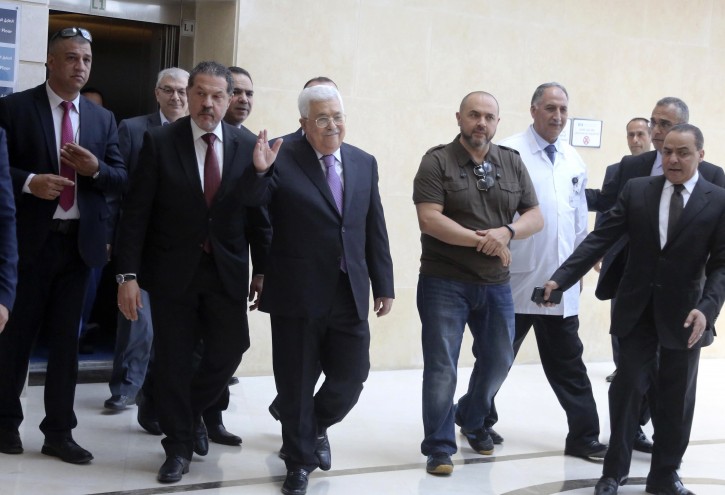 Palestinian President Mahmoud Abbas (C) walks with his sons, Yasser Abbas (C-L) and Tarik Abbas (C-R) as he leaves the hospital, in Ramallah, 28 May 2018.EPA