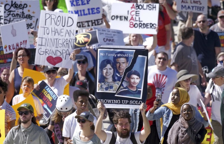 Activists gather during a rally to protest the Trump administration's approach to illegal border crossings and separation of children from immigrant parents Saturday, June 30, 2018, in Salt Lake City.  (AP Photo/Rick Bowmer)