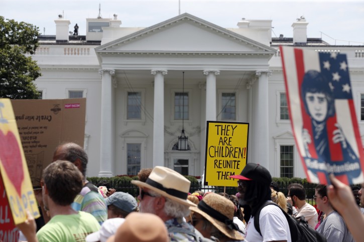 Activists march past the White House to protest the Trump administration's approach to illegal border crossings and separation of children from immigrant parents, Saturday, June 30, 2018, in Washington. (AP Photo/Alex Brandon)
