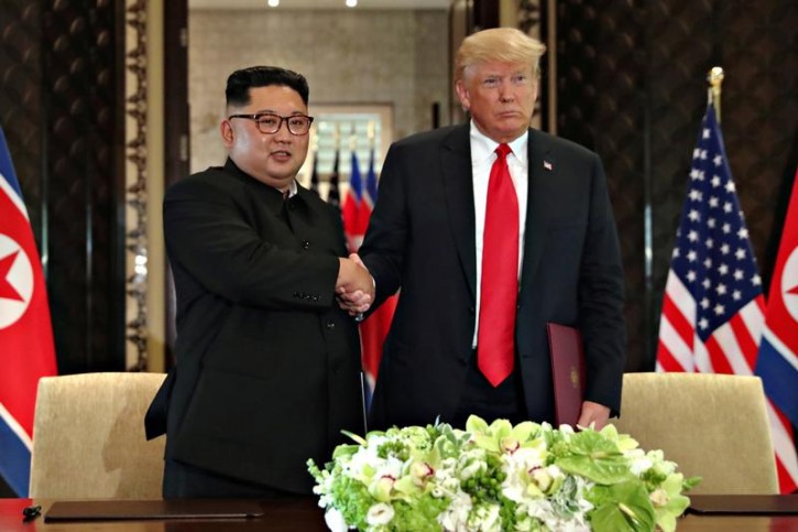 U.S. President Donald Trump shakes hands with North Korea's leader Kim Jong Un after they signed documents that acknowledged the progress of the talks and pledge to keep momentum going, after their summit at the Capella Hotel on Sentosa island in Singapore June 12, 2018. REUTERS/Jonathan Ernst