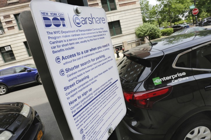 An Enterprise CarShare vehicle occupies a parking space in one of the new designated Carshare areas, this one on New York's Upper West Side, Friday, June 1, 2018. (AP Photo/Richard Drew)
