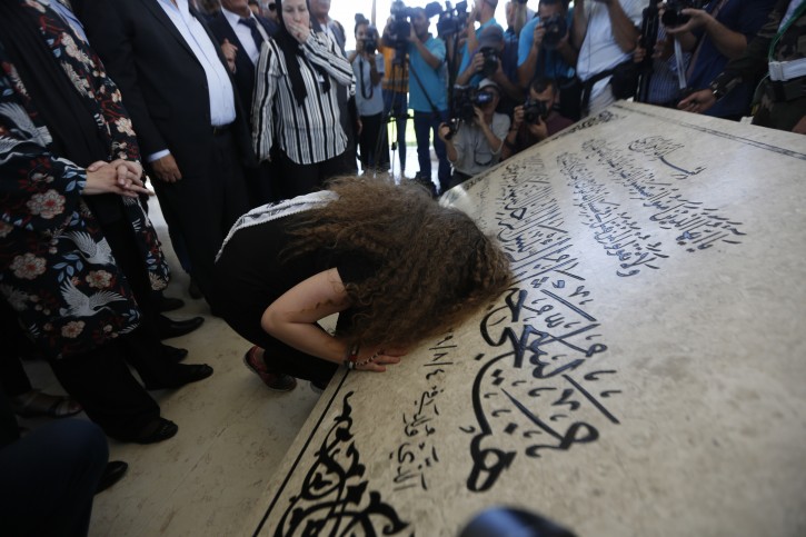 Ahed Tamimi prays at the tomb of former Palestinian leader Yasser Arafat in the West Bank city of Ramallah, Sunday, July 29, 2018. AP