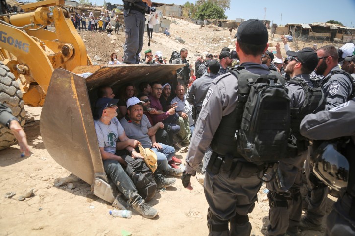 Israeli policemen scuffle with Palestinian demonstrators in the Bedouin village of al-Khan al-Ahmar east of Jerusalem on July 4, 2018July 4, 2018. Photo by FLASH90