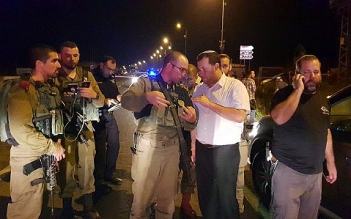 FILE - Samaria Regional Council Chairman Yossi Dagan (2nd right) speaks with a soldier at the scene where Hava Roizen was run over and killed by a Palestinian driver, near the northern West Bank settlement outpost of Havat Gilad on August 16, 2018. (Roi Hadi/Samaria Regional Council)