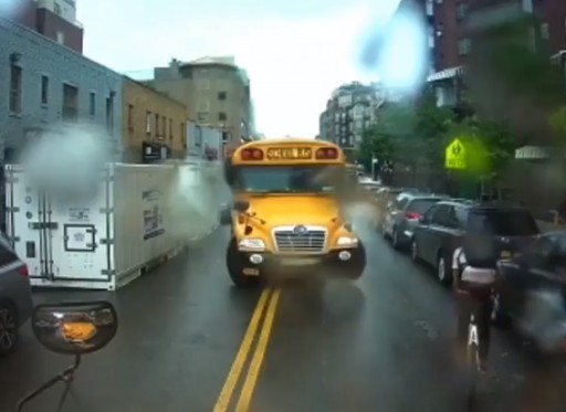 Image taken from video shows one school bus driver using his bus to stop a cyclist who had just passed a school bus whose red lights were flashing.